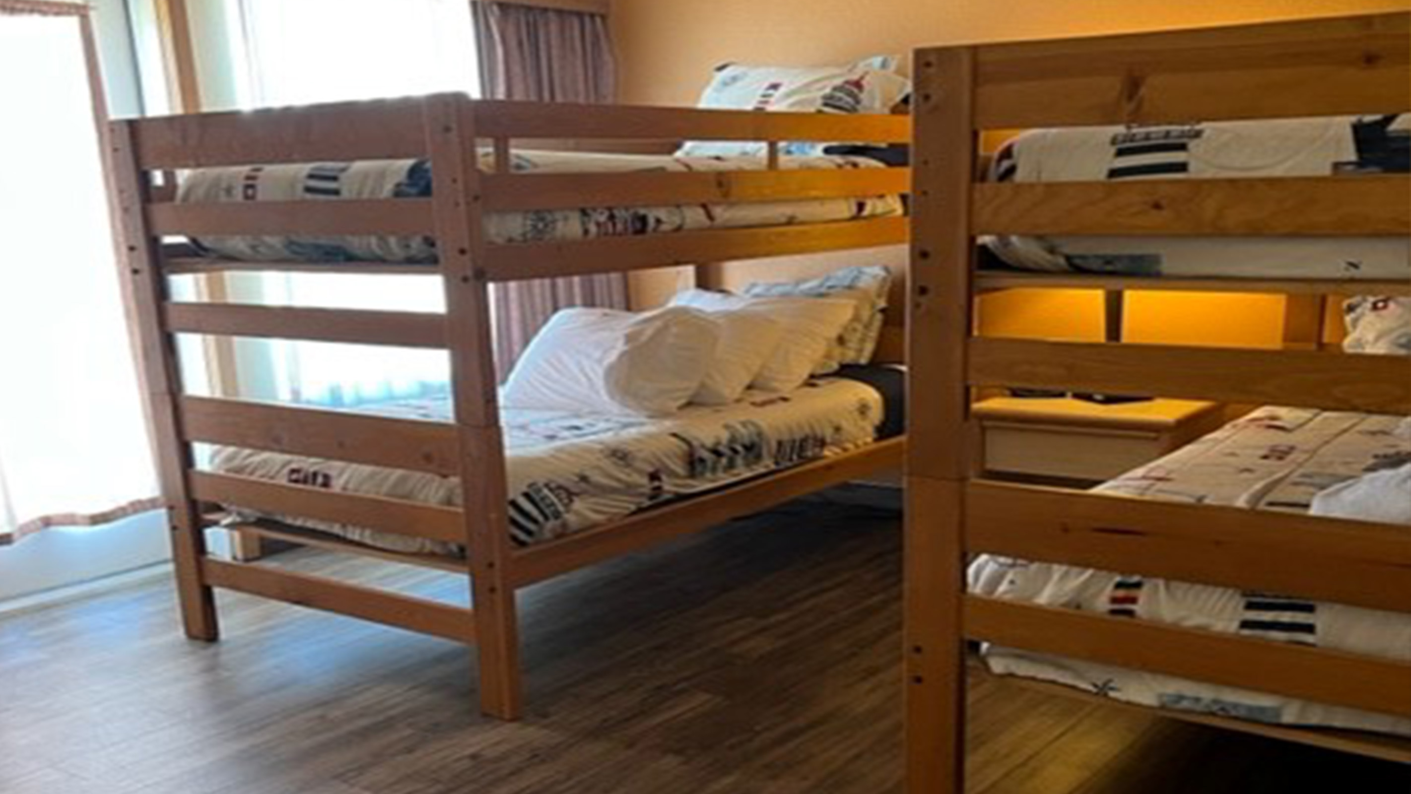 Two twin bunk beds with brown wood